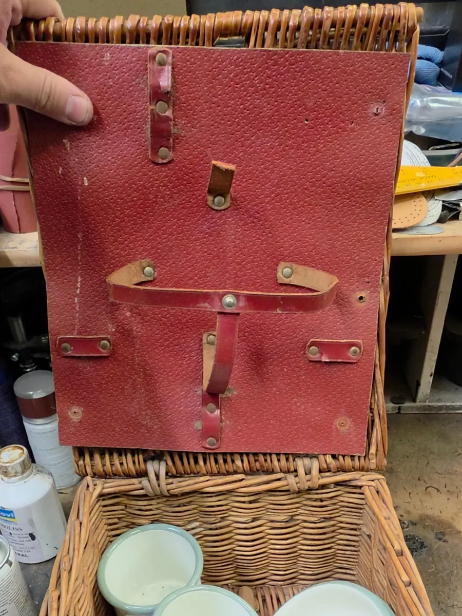 Wicker picnic hamper with a cracked red leather lining