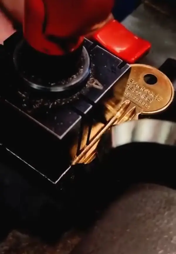 Cutting a brass key on the key machine