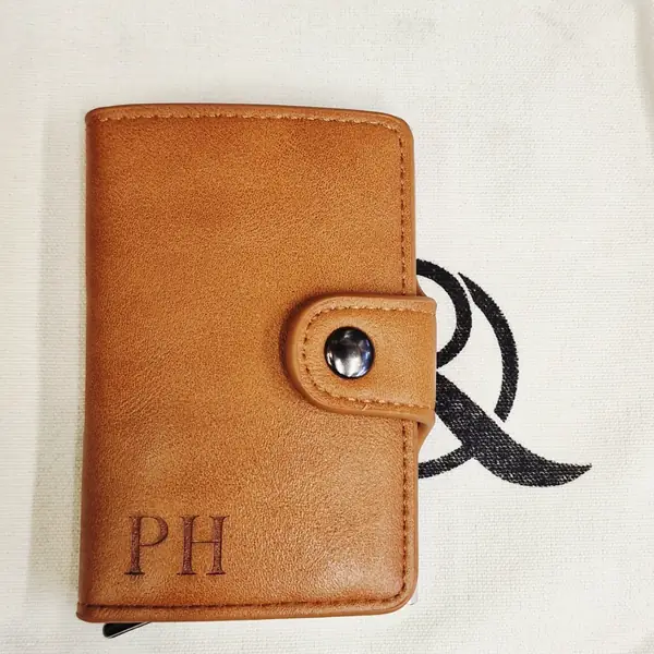 Initials engraved on a leather card wallet