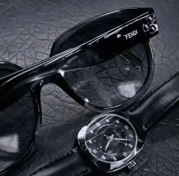 Fendi sunglasses and a watch on leather