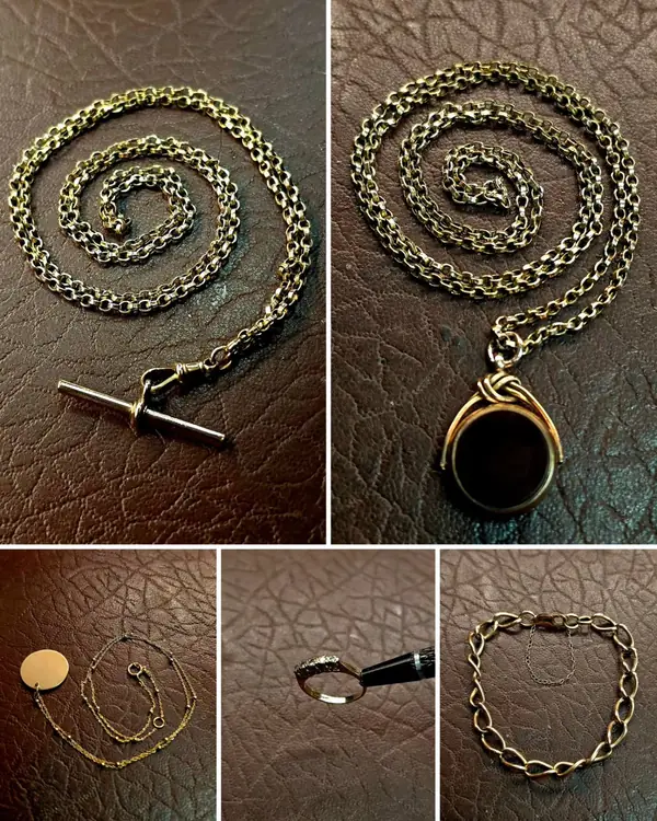 Gold Albert watch chains, a seal fob and bracelets laid out after repair