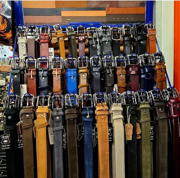 Leather belts for sale on a display rack