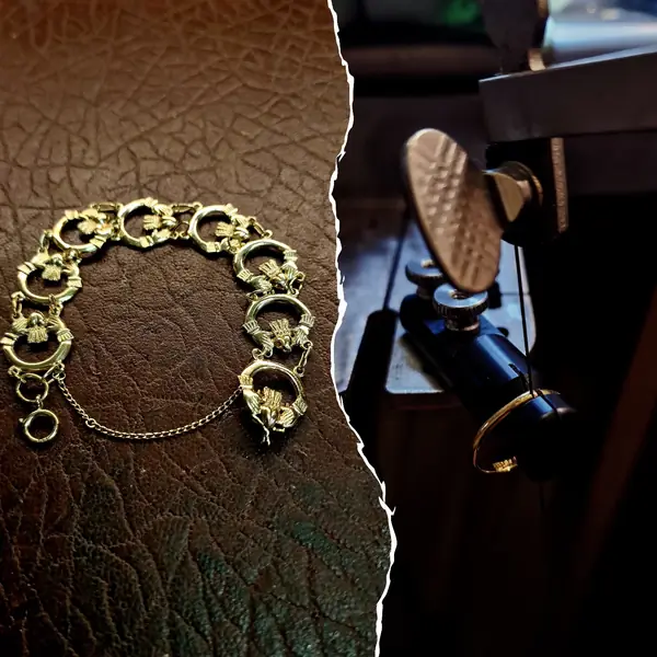 Ornate gold bracelet, with a gold ring held in a jig for repair