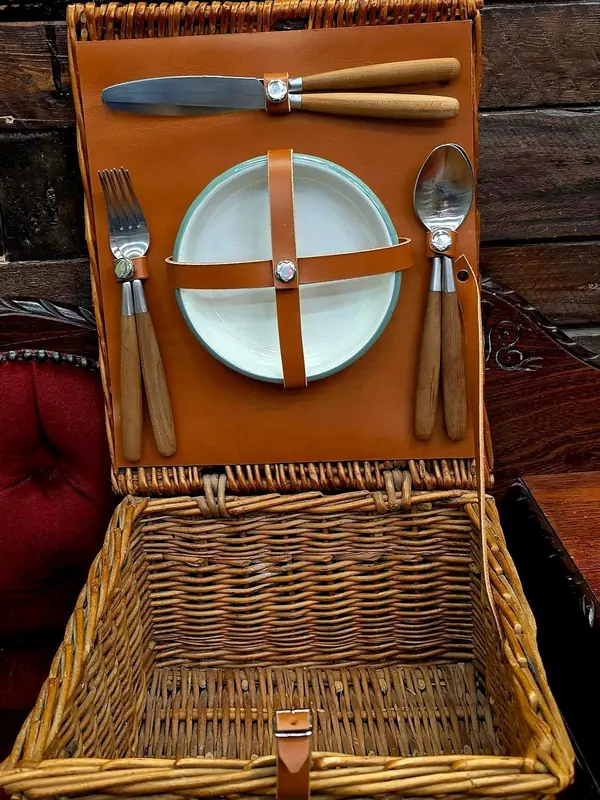 Wicker picnic hamper with a new tan leather panel and straps