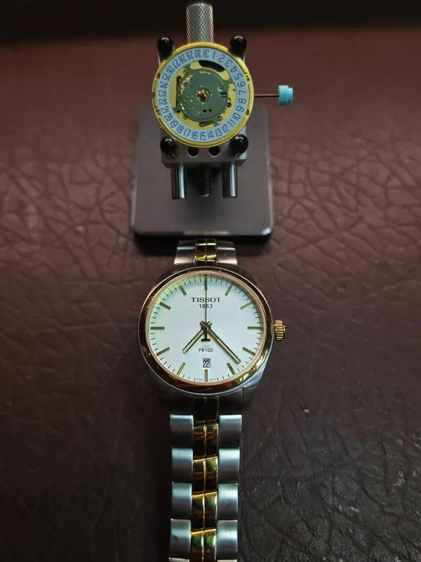 Two-tone Tissot quartz watch, with its movement in a holder